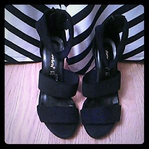 Black ankle strapped heels paired w the red ones