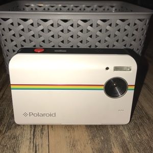 Polaroid camera (prints photos out on the spot).