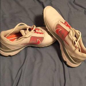 White grey and red Nike running shoes