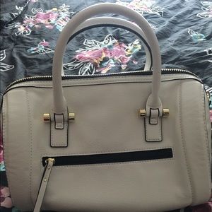 White trimmed in gold purse by Aldo
