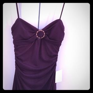Women's purple high low dress with open back.