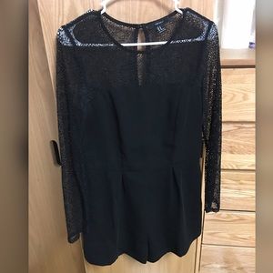 A black romper with lace arms and chest