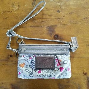 Coach poppy clutch with shoulder strap.