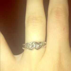 A silver and gold heart infinity ring