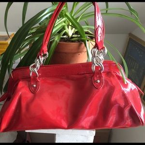 Red purse with silver colored details on handles
