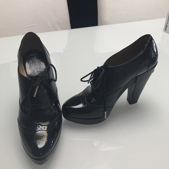 Michael Kors patent leather lace up booties.