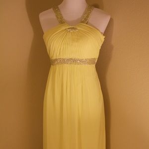Floor length chiffon yellow open back dress.