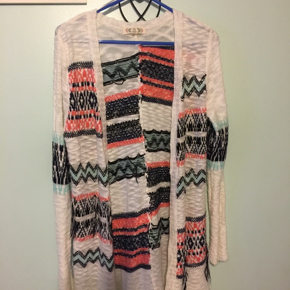 Unique sweater with tassels on the side.