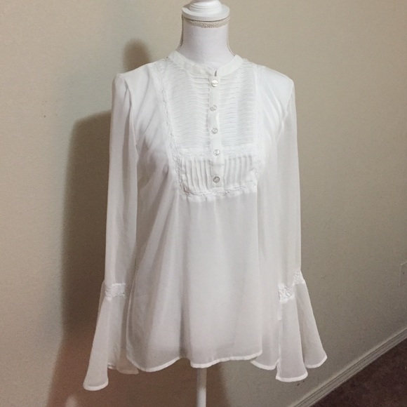 Ruffle blouse with pleating and lace detail.