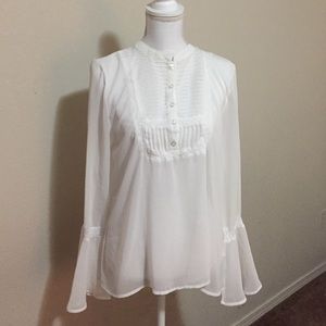 Ruffle blouse with pleating and lace detail.