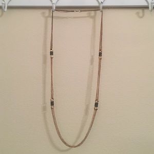 Long gold necklace with gray jewels