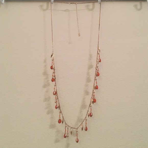 Long gold necklace with orange stones