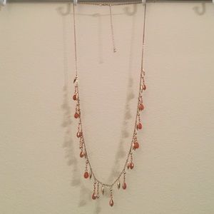 Long gold necklace with orange stones