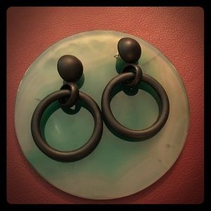 Black circular metal earrings.