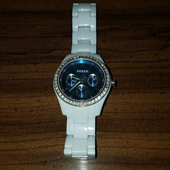 White fossil watch with blue face.