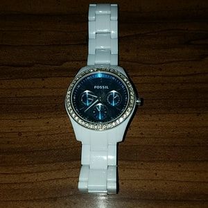 White fossil watch with blue face.