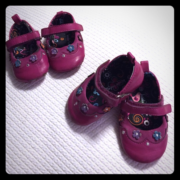 Adorable pink shoes with colorful flowers.