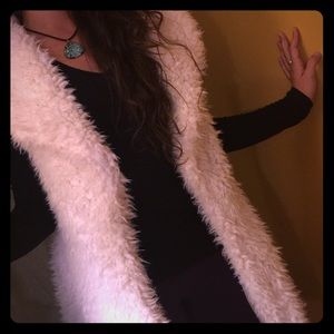 White faux fur vest.