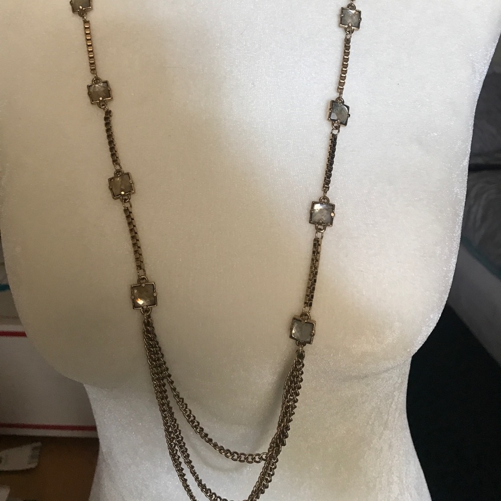 gold colored long necklace w/ gem stones