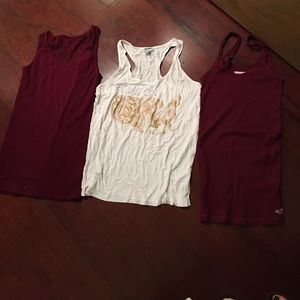 Two maroon tanks, one white tank