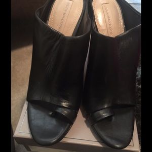 Black leather open back shoe.