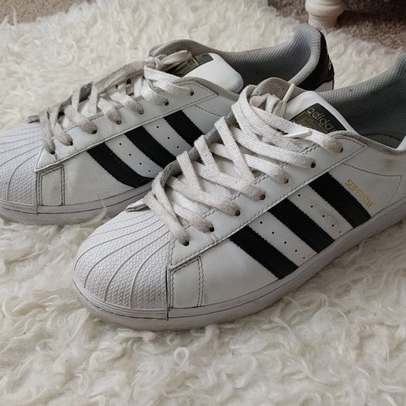 Black and white adidas superstars