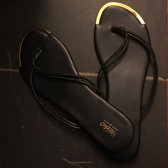 Black and gold flip flops