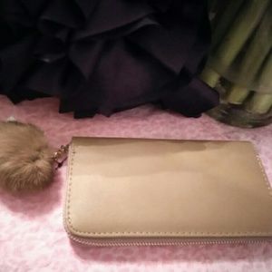 Wallet with fur ball attached