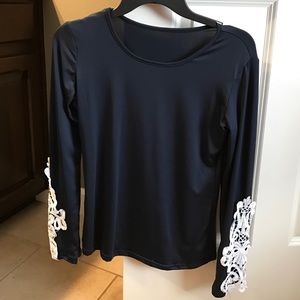 Women's blue blouse with white lace overlay sleeve