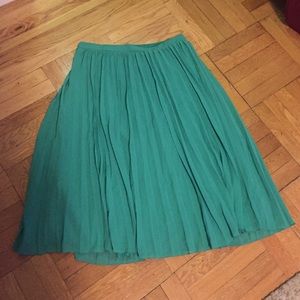 Pleated skirt sheer polyester skirt with lining.