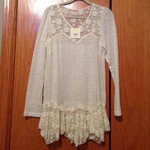 Long sleeve cream colored top.