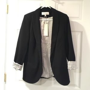 Black blazer with silk design.
