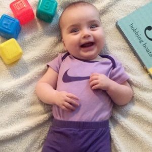 Purple Nike swish onesie