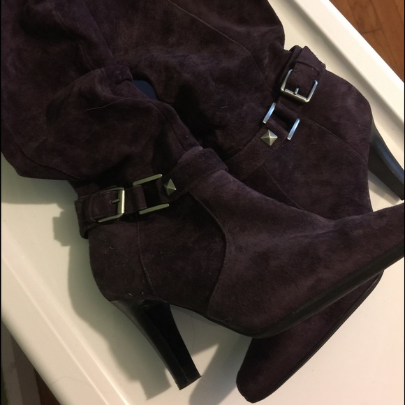 Purple suede high-heeled boots.