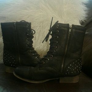 Black leather lace up boots.