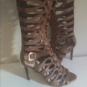 Under the knee leather caged high heel boots.