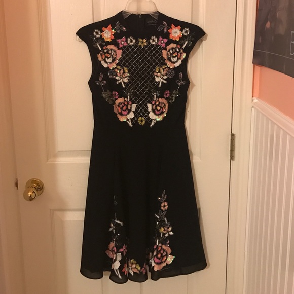 Black hand stitched needle and thread dress