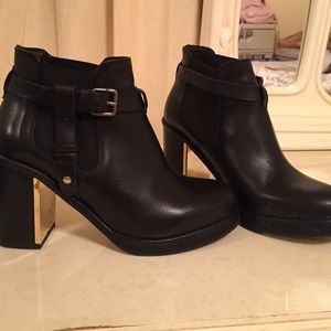 Black booties with gold plated mirrored inner heel