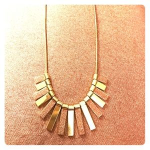 Gold necklace with shimmery pink accents.