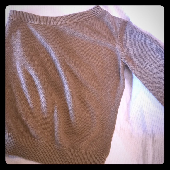 One sleeve tan sweater.