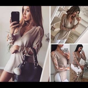 Criss cross sleeve sweater.