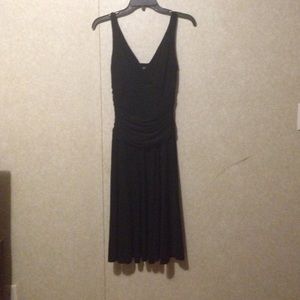 Black dress with a fitted top and flowing bottom.
