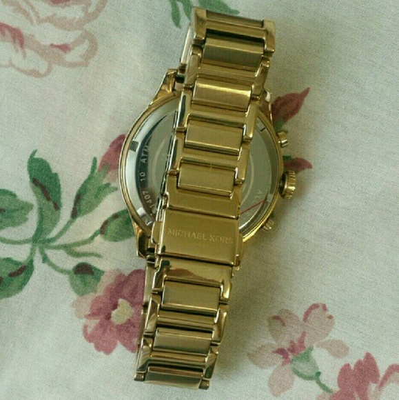 MK pink face gold toned watch