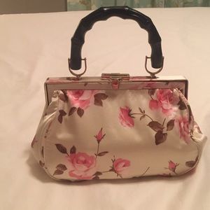 Cream satin bag with pink roses, bamboo handle.