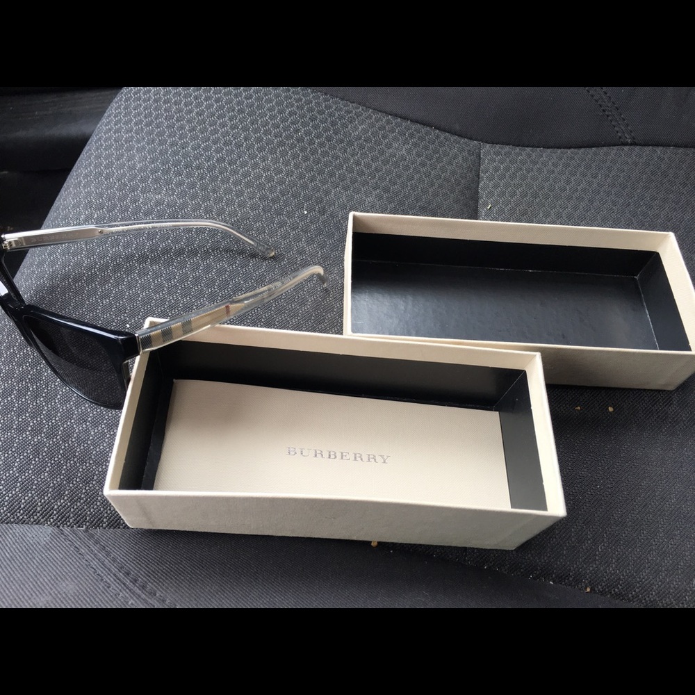 Burberry: Maroon tint/clear arm Sunglasses.