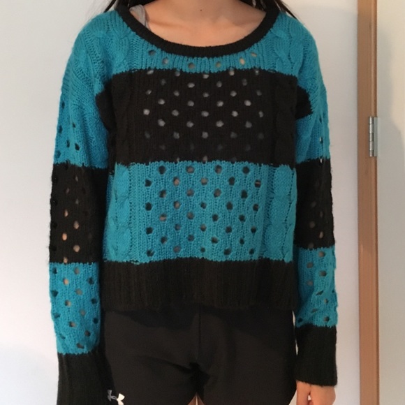 a blue and black striped sweater with holes
