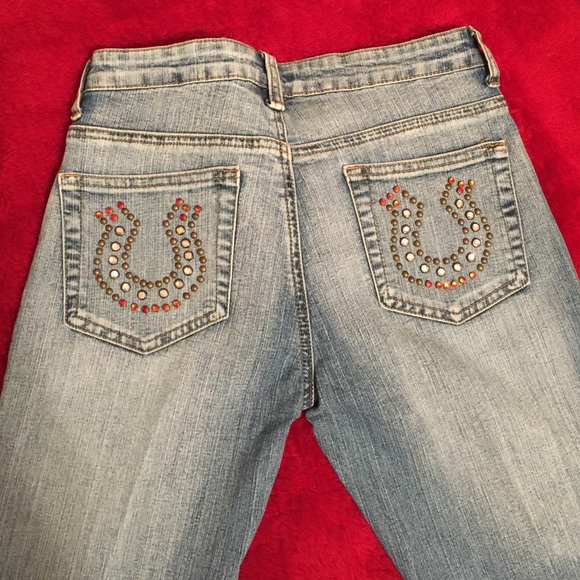 Jeans with rhinestone and stud horseshoe designs