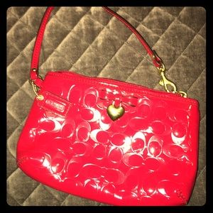 NWOT red Coach wristlet w. bow/heart embellishment