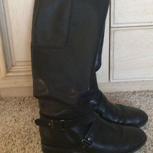 Knee length black boots.