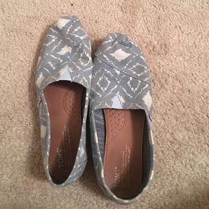 Blue and white TOMS shoes
